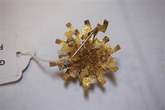 A 1970s? textured 18ct gold, diamond and sapphire set stylised starburst brooch, 43mm.